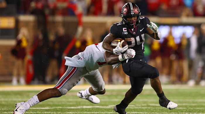 Sep 2, 2021; Minneapolis, Minnesota, USA; Minnesota Gophers running back Mohamed Ibrahim (24) runs the ball as Ohio State Buckeyes cornerback Ryan Watts (16) attempts to tackle him during the second quarter at Huntington Bank Stadium.